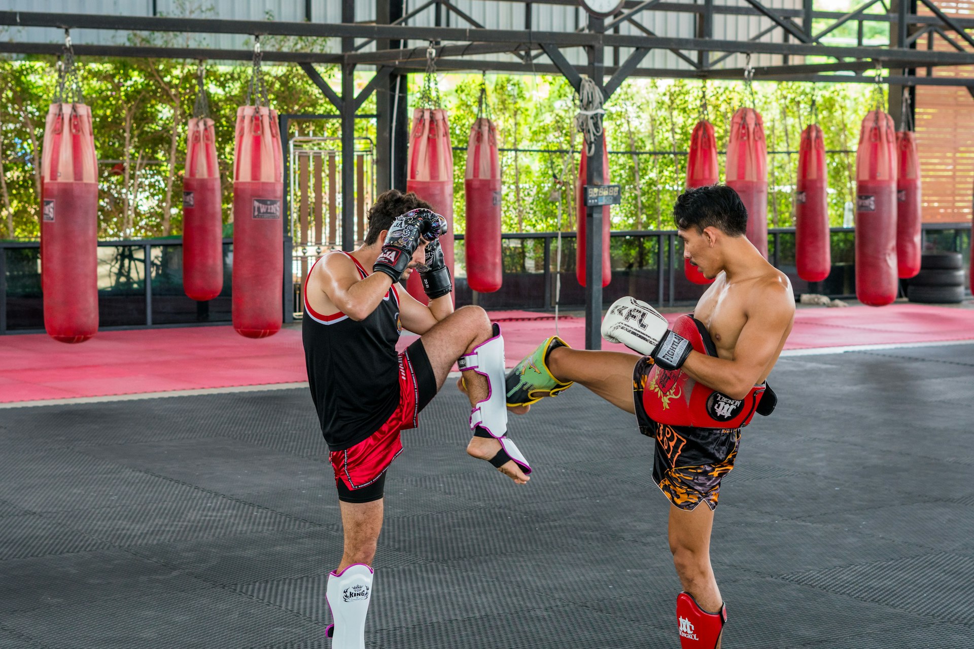 A couple of men standing next to each other in a gym